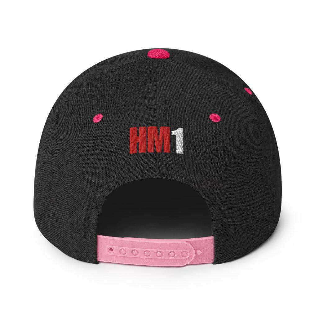 Back view of a black snapback hat with pink details and "HM1" embroidery, featuring an adjustable snap closure.
