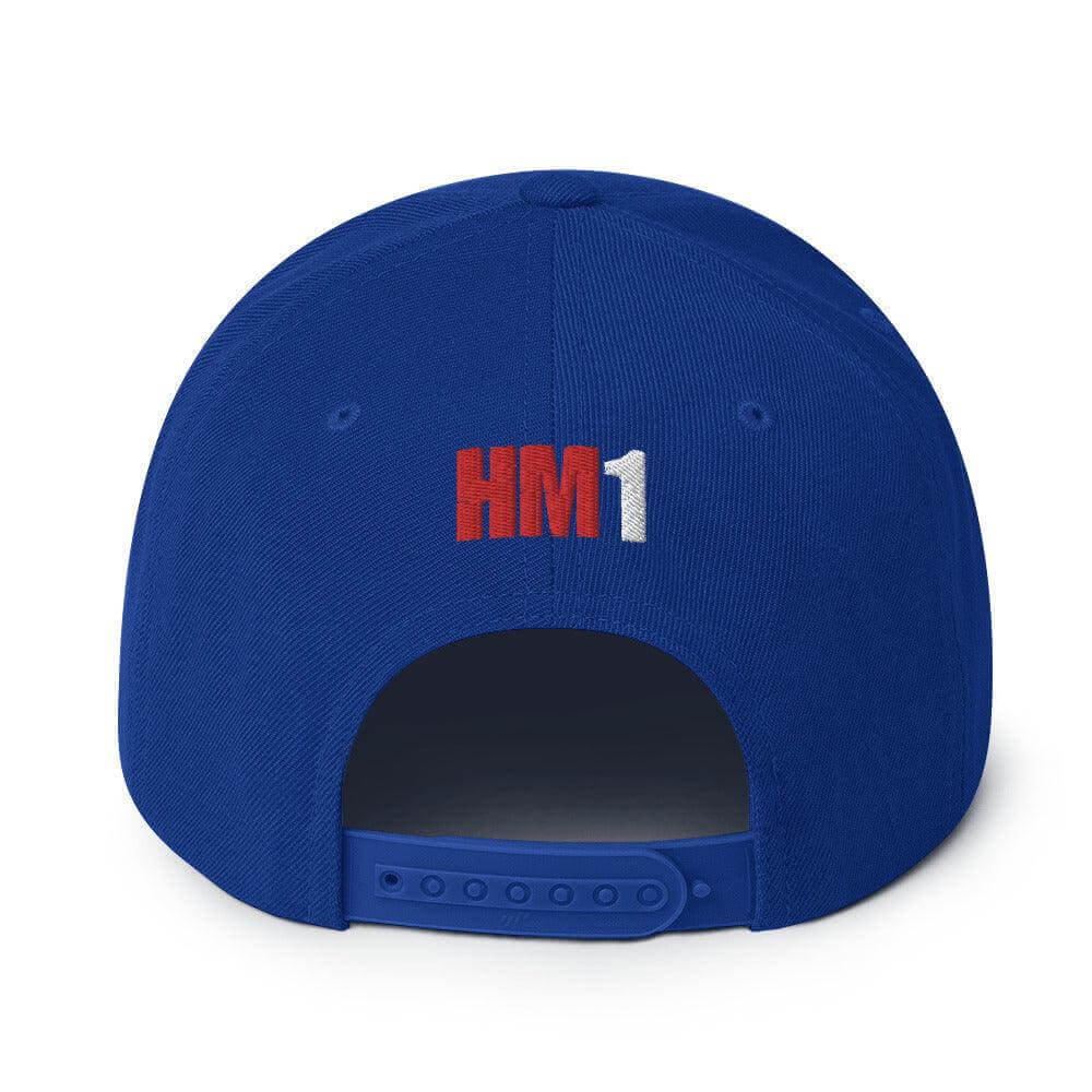 Back of blue snapback hat with embroidered "HM1" design and adjustable plastic snap closure. Ideal for firefighter gear.