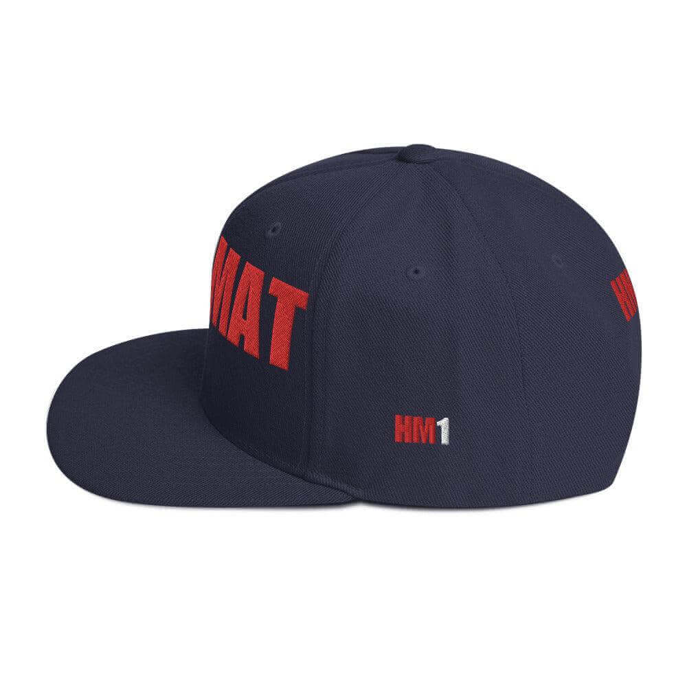 Snapback hat with red "HMAT" lettering, structured design, and flat brim, ideal for firefighter apparel and gifts.