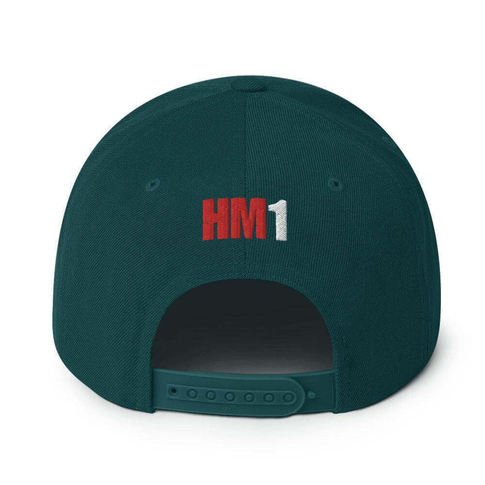 Back view of structured green snapback hat featuring embroidered "HM1" and adjustable plastic snap closure.