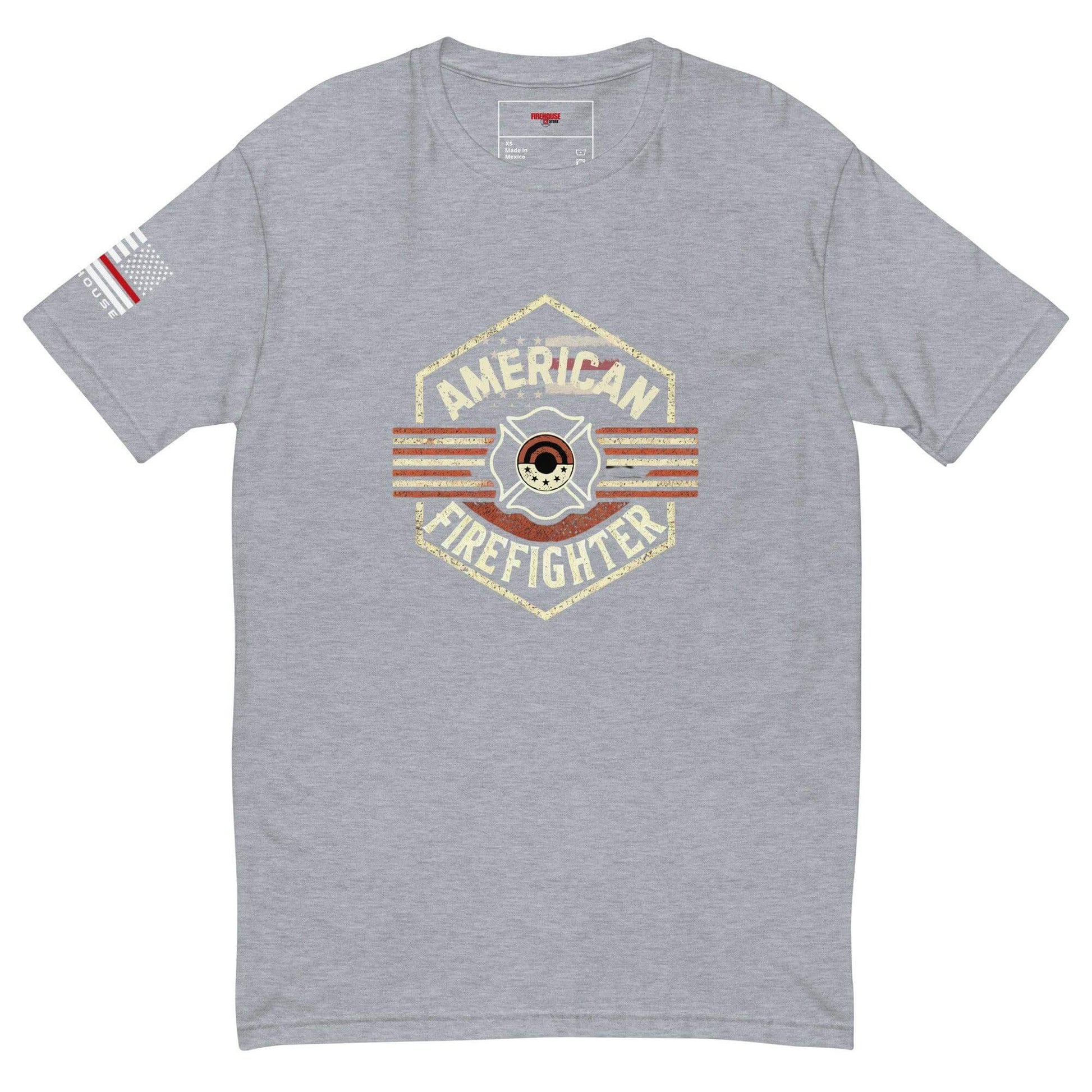 Grey short sleeve t-shirt with "American Firefighter" graphic and American flag emblem, perfect for firefighter apparel gifts.