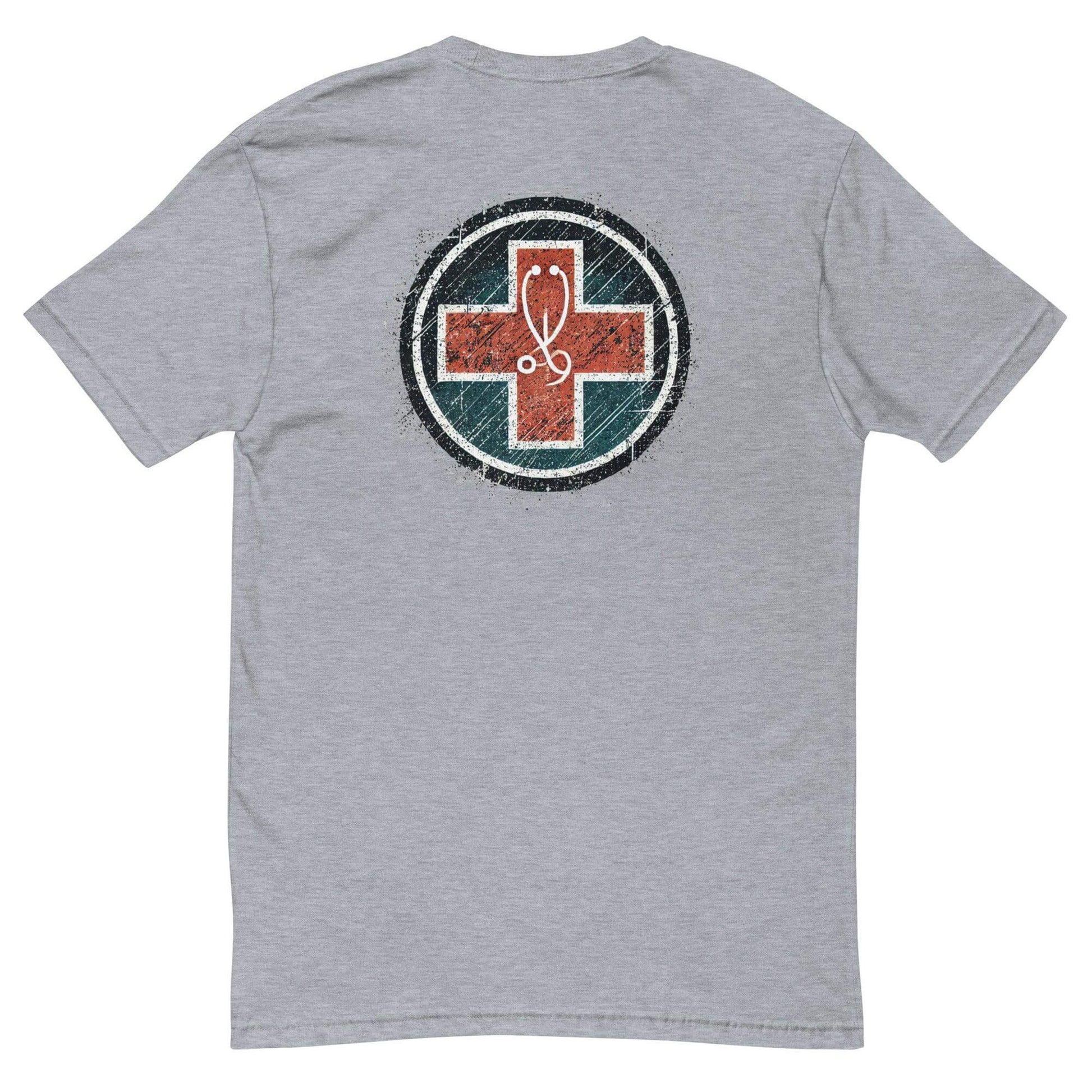 Back view of a grey short sleeve t-shirt featuring a circular emblem with a red cross design. Ideal firefighter apparel.