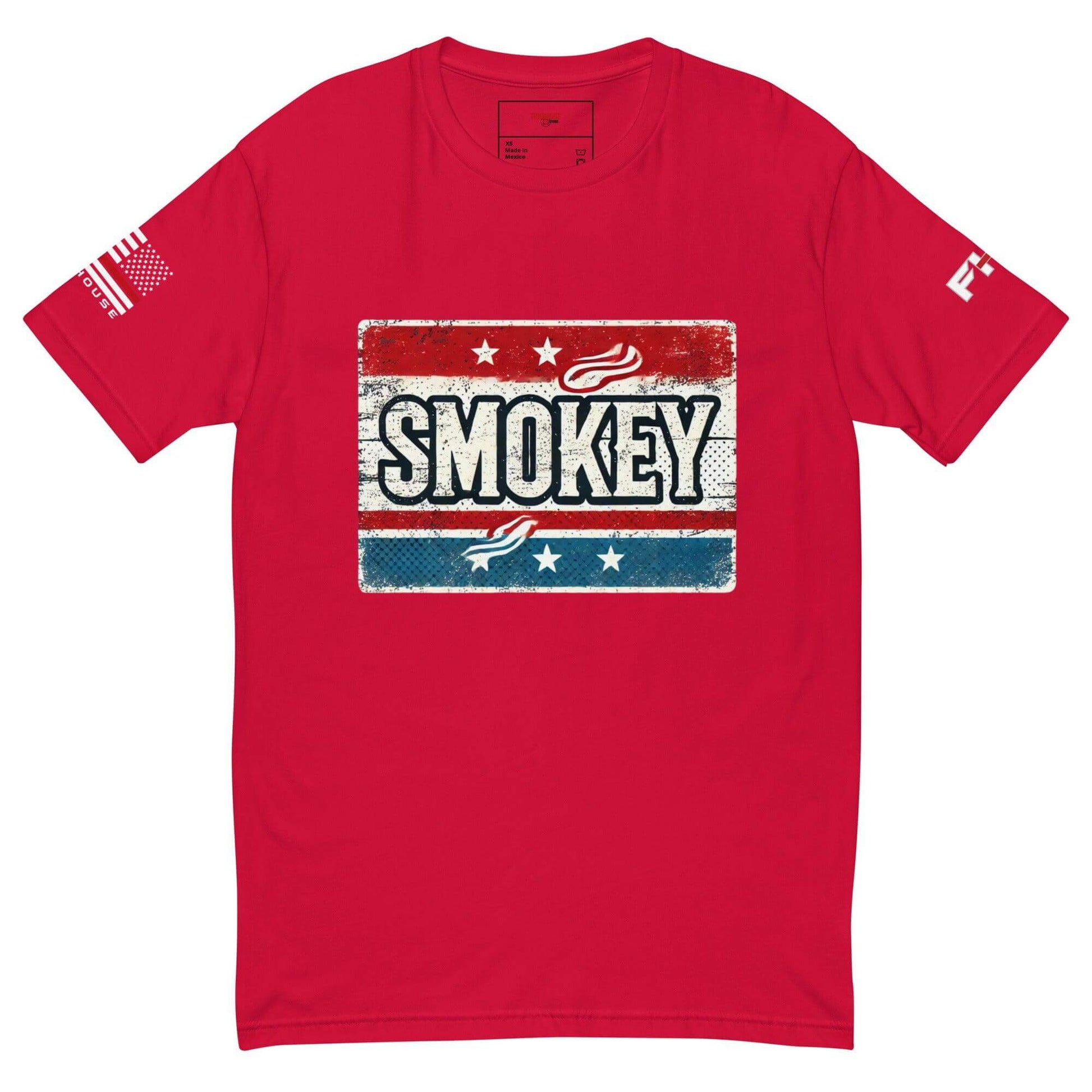 Red t-shirt featuring "Smokey" graphic and American flag, perfect for firefighter apparel and gifts.